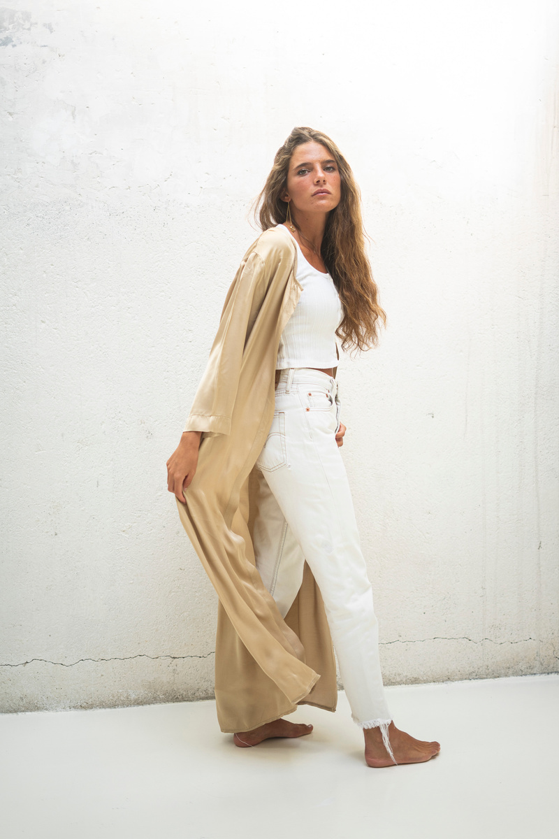 Woman in WhiteCrop Top and White Pants with Beige Outerwear